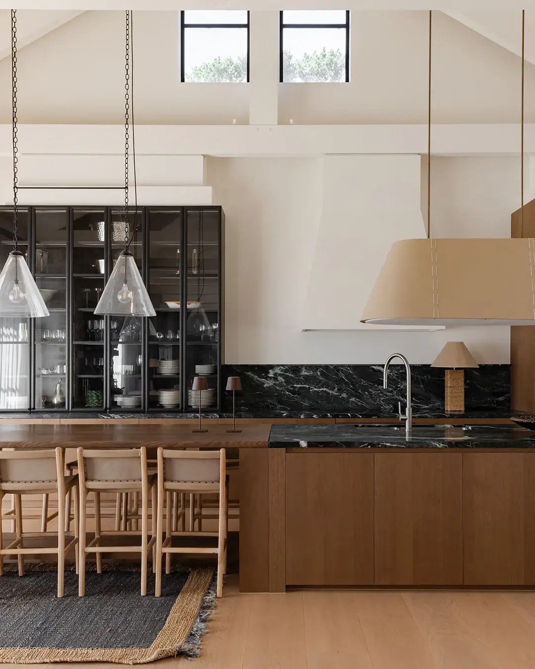 Red Hill home kitchen and dining area featuring Bayonne veneer cabinetry complemented by matching timber flooring.